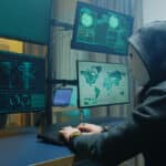 side-view-of-masked-hacker-writing-a-dangerous-mal-2022-03-31-23-19-26-utc-1.jpg
